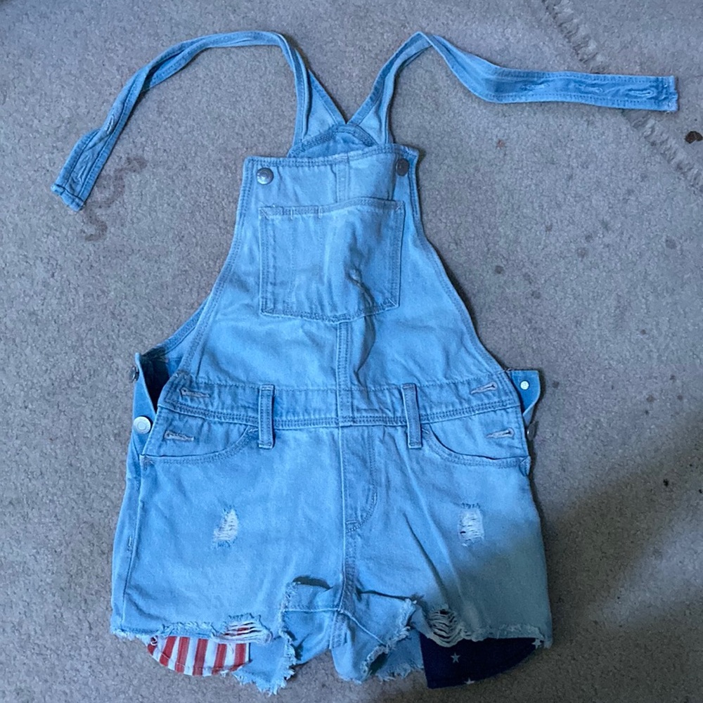 Old Navy overalls, American Flag pocket. The overalls button on the sides.
